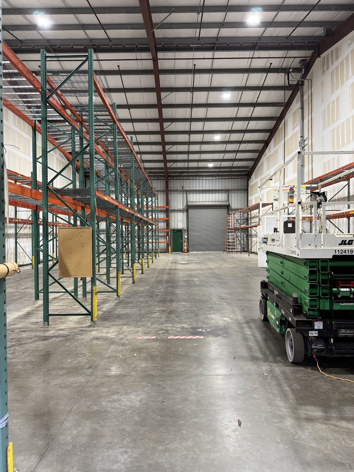 Commercial warehouse interior with installed overhead lighting
